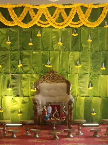 A slightly different angle of our popular banana leaf backdrop for a Seemantham ceremony. The lighting highlights the texture of the leaves and the brightness of the marigold flowers.