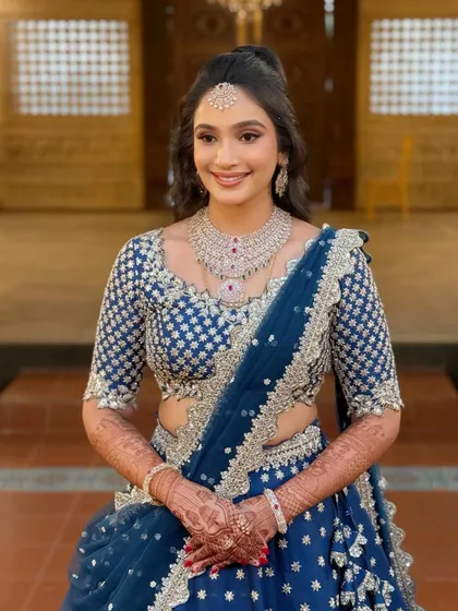 A smiling portrait of the bride, showcasing her minimal yet glamorous reception makeup. The look is fresh, modern, and effortlessly beautiful.