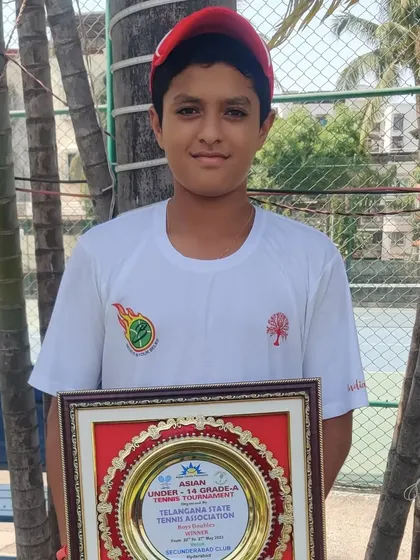 Om Verma proudly displays his winner's plaque from the Asian U-14 Grade A doubles event. Success at this level is a key indicator of a player's potential for a professional career.