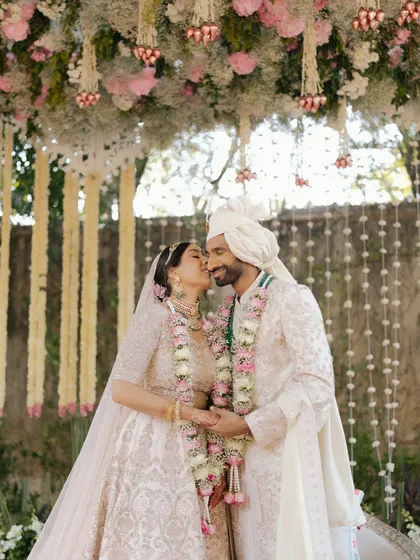A tender moment under a floral mandap at Rambagh Palace. Capturing these intimate exchanges amidst the grandeur of the ceremony is central to my storytelling approach.