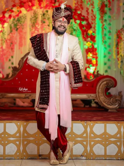 A joyful, candid portrait of the groom. His hearty laugh is infectious and shows the fun and happiness of the wedding day.
