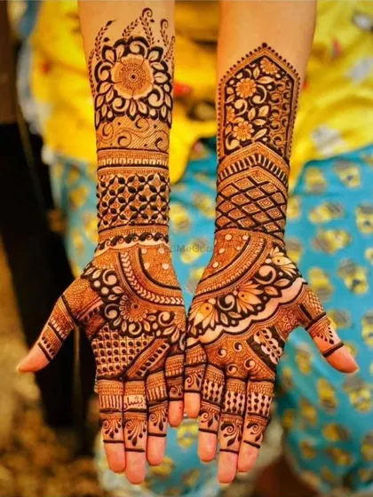 A classic and elegant full hand mehendi design. It features a mix of intricate geometric grids, floral mandalas, and traditional motifs, perfect for any festive occasion.
