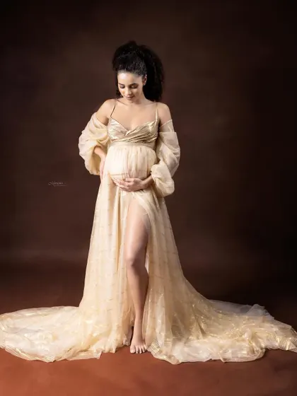 Every mother-to-be is a goddess creating life. This portrait uses golden fabrics and soft, ethereal lighting to capture that divine feminine energy in a timeless maternity photo.