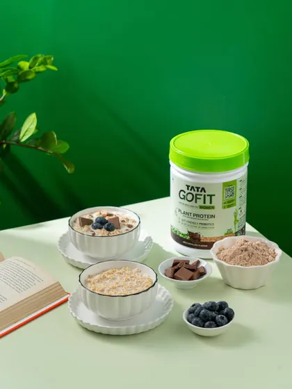 A styled shot of protein-infused oatmeal with fresh blueberries and chocolate. This image is designed for health and fitness brands.