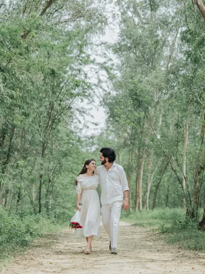A quiet walk through a wooded path. We capture the simple, intimate moments of togetherness that make your love story unique.
