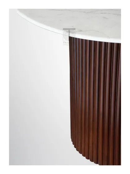 A detail of our classic fluted dining table, showing the rich texture of the wooden base and the smooth, elegant marble top.