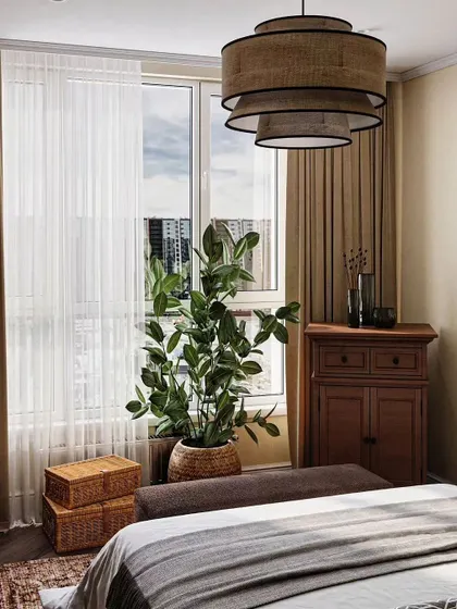 To evoke a year-round summer feeling, we designed this bedroom with tropical-inspired elements. Louvered wooden wardrobe doors, natural fiber lighting, and lush indoor plants create a warm, relaxed atmosphere reminiscent of a holiday escape.