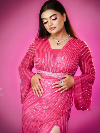 A vibrant pink outfit paired with a dramatic winged eyeliner. This look is all about making a statement.