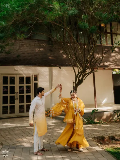 A playful dance between the couple at their outdoor Mehendi. I use the natural surroundings to frame these happy moments.