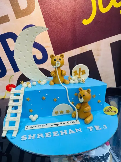 A 2kg cake celebrating a half birthday, with teddy bears fishing for stars from a crescent moon.