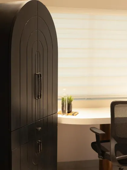 A close-up of the arched storage unit, highlighting the grooved detailing that adds texture and visual interest to the black finish.