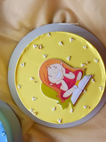 A simple and cute character cake with a yellow buttercream finish, perfect for a small celebration.
