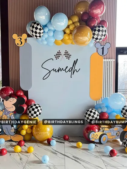 A Mickey Mouse race car theme, combining two popular ideas into one exciting party. The checkered-flag balloons and race-themed Mickey cutout are key details.