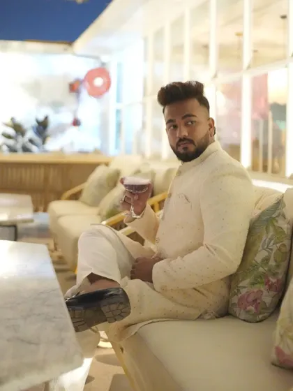 For a festive celebration, this client chose a classic ivory embroidered achkan-style kurta, looking relaxed and stylish.