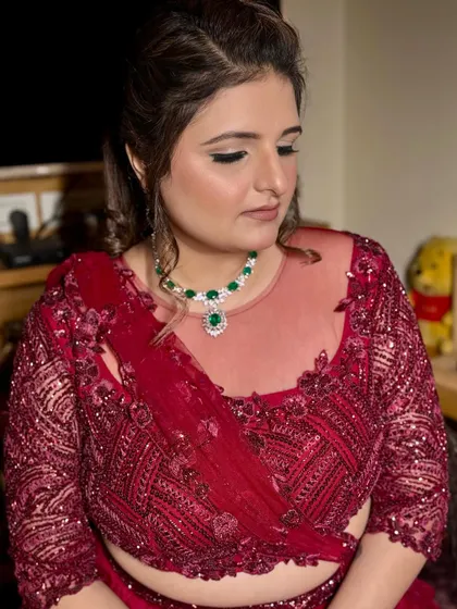 Ready for the cocktail night in a stunning wine-red outfit. The makeup is glamorous, with a defined eye and glowing skin to match the celebratory vibe.