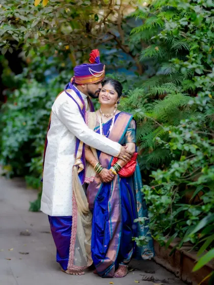 A sweet, candid moment of the groom kissing his bride on the cheek as they walk together.