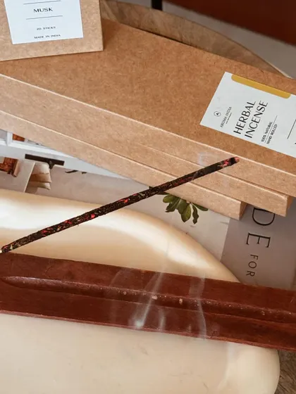 A close-up of our herbal incense burning, releasing its sacred and powerful aroma. Incense is beneficial for cleansing energy, attracting harmony, and deepening yoga and meditation practices.