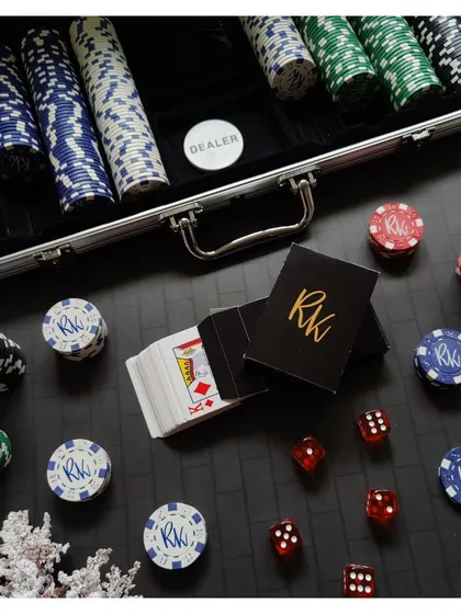 A close-up of the personalized poker set, showing the custom initials on the playing cards and chips. The attention to detail makes this a truly special and memorable gift for any card game lover.