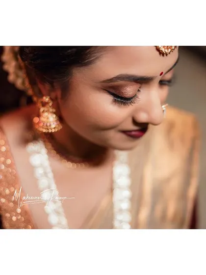 A soft, downward glance showing off the beautiful shimmer on her eyelids.