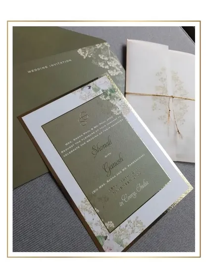 Another angle of the minimal floral elegance suite, showcasing the main invitation card with its gold border and custom monogram.