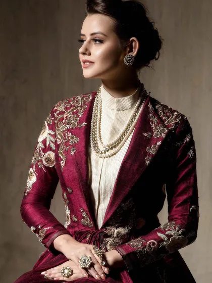A classic portrait focusing on the upper body, drawing attention to the pearl necklace and detailed embroidery. The soft, directional lighting beautifully models the subject's face and the outfit's texture.