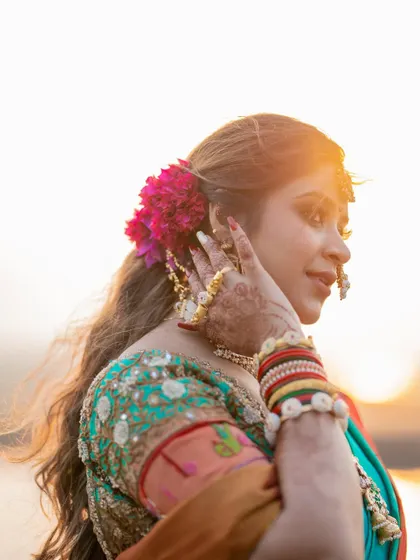 A beautiful golden hour portrait of a bride, with the setting sun creating a stunning backlight and highlighting her features.