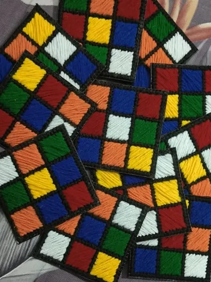 Feeling nostalgic for the Rubik's Cube? We've turned the iconic puzzle into a set of colorful coasters. Each square is individually stitched to create this fun, retro design.