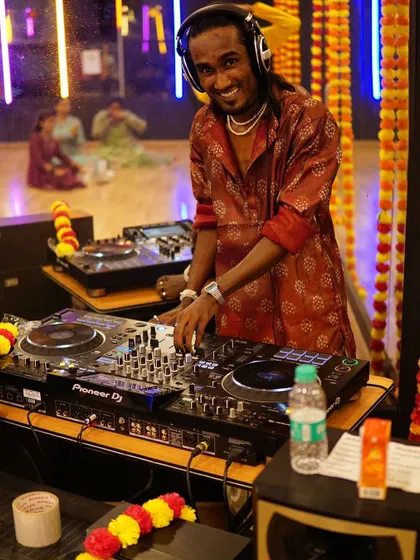 Our DJ setting the mood for the Garba and Dandiya night. The right music is key, and we help curate the perfect playlist for your event.