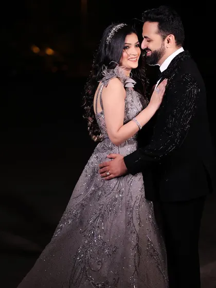A classic, romantic portrait against a dark night sky. The couple's elegant attire and loving gaze create a timeless and sophisticated image.
