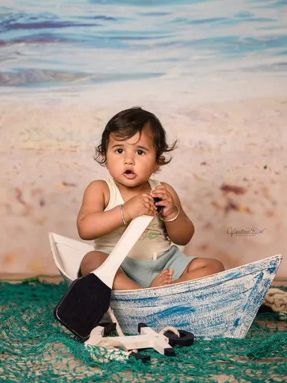 Explore our full nautical and beach-themed collection. These images showcase the variety of poses and angles possible with our boat prop, sand-colored flooring, and ocean backdrop.
