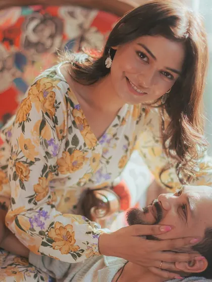 An intimate and relaxed portrait from an indoor session, showing the couple's comfortable and affectionate connection.