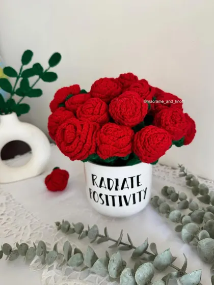 A full bouquet of vibrant red crochet roses in a "Radiate Positivity" mug. This is more than a gift; it's a beautiful decor piece that brings warmth and color to any room.