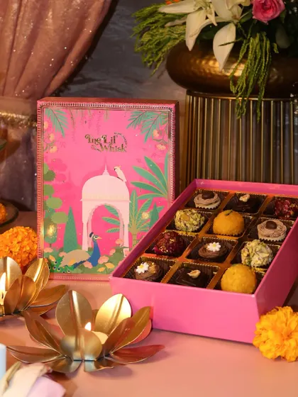 Introducing our Peacock Paradise sweets box in a stunning pink design. It's a royal indulgence filled with 12 of our most popular assorted sweets, perfect for gifting.
