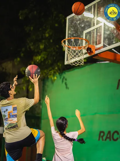 Two players practicing their shooting, with one elevating for a jump shot. I encourage players to support each other and grow together.