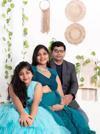 A beautiful family maternity portrait. We have matching outfits for kids too, like this lovely blue dress that coordinates with the mother's gown.