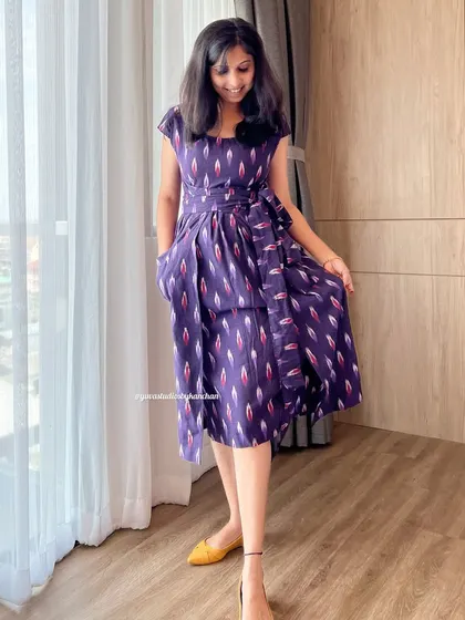 I designed this purple Ikat pinafore dress for a chic and comfortable fit. The side tie adds a lovely detail, and the pure handloom fabric feels wonderful against the skin.