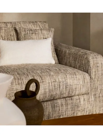 Neutrals and texture are a timeless combination. This sumptuous, heavily textured fabric is perfect for a comfortable, inviting armchair, proving that a neutral palette can be rich and full of character.