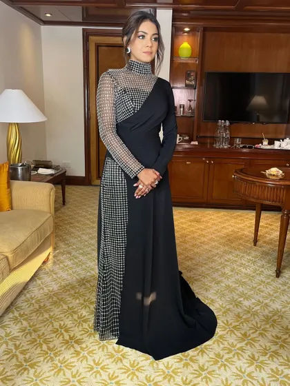 A full-length shot showing how this sleek updo contributes to an overall look of grace and sophistication.