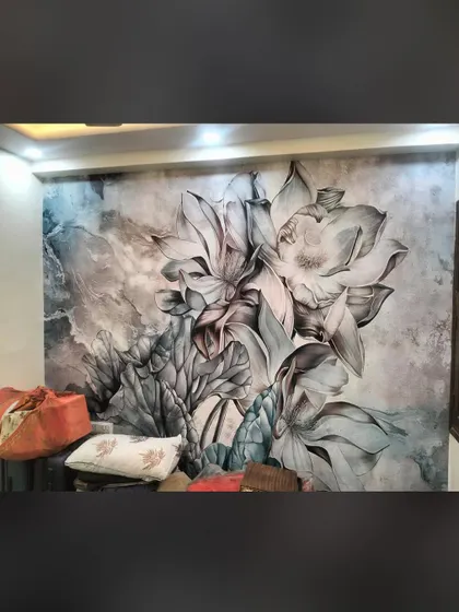 A large-scale floral mural in grayscale tones makes a powerful statement. Even without bright colors, the size and detail of the flowers create a stunning visual impact.