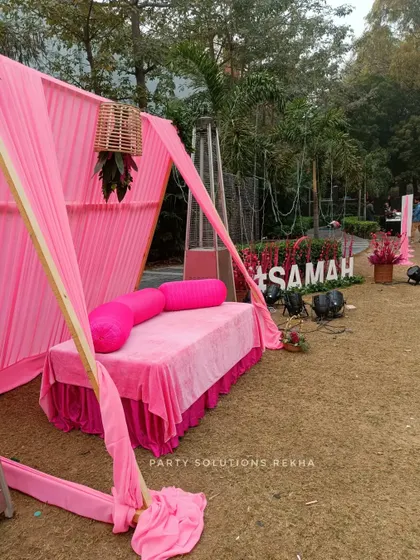 A full view of the pink-themed Mehendi setup, featuring a comfortable seating area and the personalized "#SAMAH" hashtag sign in the background.