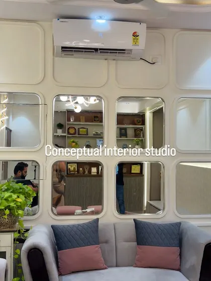 This living room wall features a unique design with square panels and convex mirrors, creating an interesting visual effect and making the space feel larger.