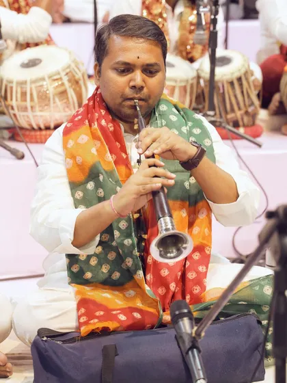 A shehnai player performs on stage, adding a traditional and auspicious musical element to the event. Our artist coordination includes a wide variety of musical talents.