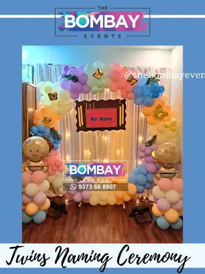 Another beautiful naming ceremony for twins. This setup uses a soft pastel color palette and a wooden frame to announce the names.