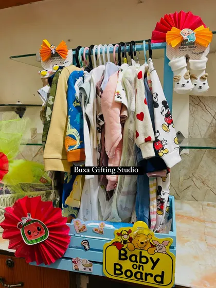 The "Baby on Board" hamper, filled with a wardrobe of adorable clothes, including Mickey Mouse and heart-printed onesies.