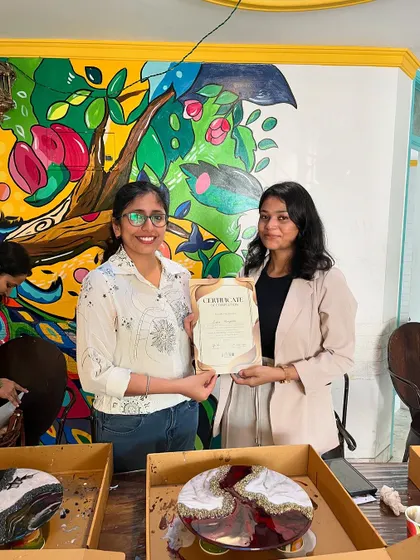 A proud moment for a participant of the resin art workshop, certificate in hand and a beautiful geode clock ready to take home.