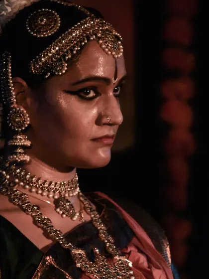 A close up of dancer Malini Agrahar, capturing the intensity and emotion of her performance.