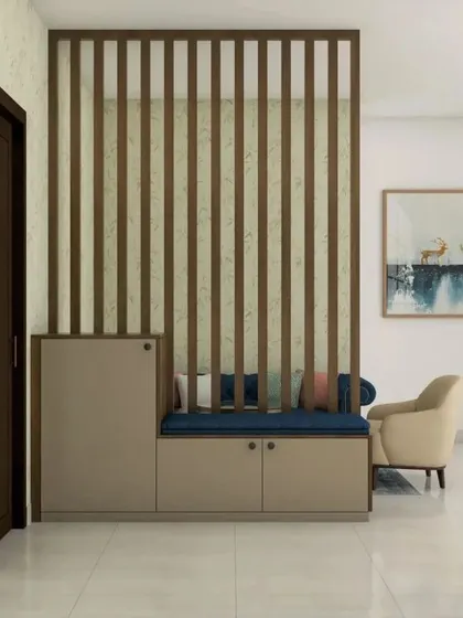 A simple wooden slat partition separates the entryway from the main living space. The attached bench with a blue cushion and storage cabinets makes for a practical and stylish solution.