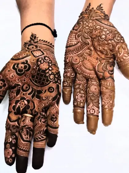 A striking design with a mix of fresh paste and developing stain, showing the different stages of the henna process.