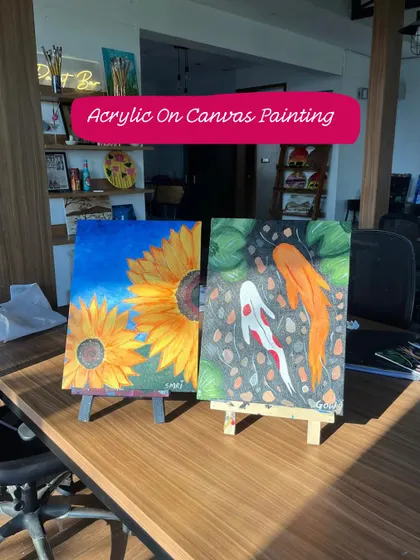 A display of different painting styles available at our workshops, including sunflower and koi fish acrylic paintings.