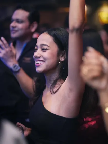 A huge smile and hands in the air. The perfect reaction.